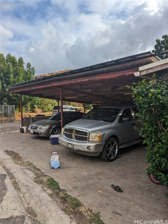 view of parking / parking lot featuring a carport