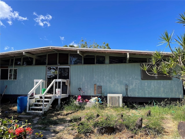 rear view of house featuring ac unit