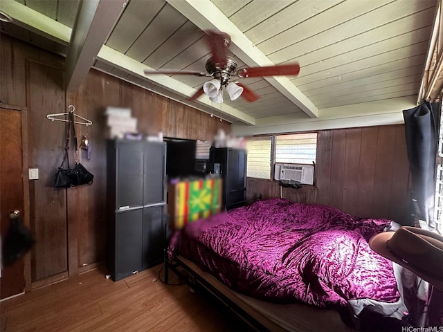 bedroom with black refrigerator, light wood finished floors, wooden walls, wooden ceiling, and beamed ceiling