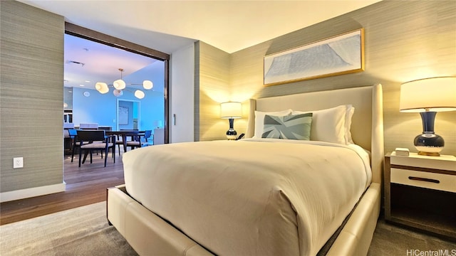 bedroom featuring a chandelier and wood-type flooring