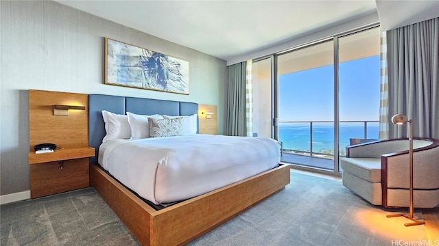 bedroom featuring dark carpet, a water view, access to outside, and floor to ceiling windows