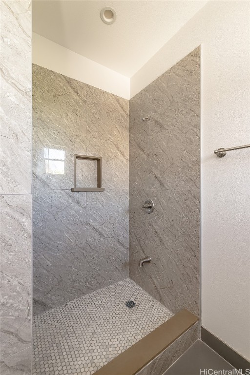 bathroom with a tile shower