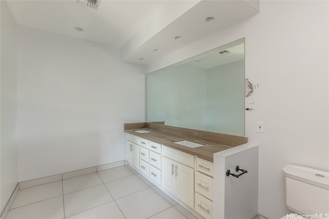 bathroom featuring toilet, vanity, and tile patterned flooring