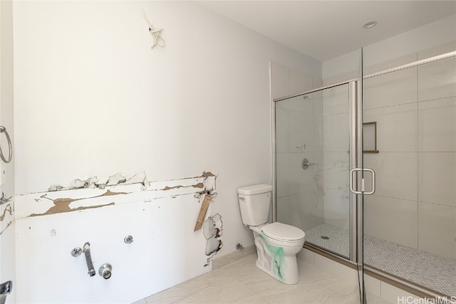 bathroom with a shower with door, tile patterned floors, and toilet