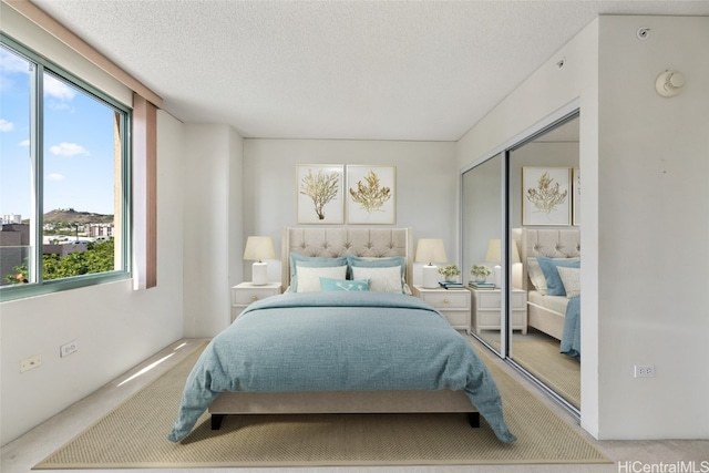 carpeted bedroom featuring a closet, a textured ceiling, and multiple windows