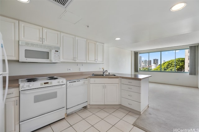 kitchen featuring kitchen peninsula, sink, light colored carpet, white cabinetry, and white appliances