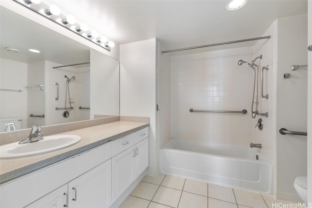 full bathroom featuring tiled shower / bath, vanity, toilet, and tile patterned flooring