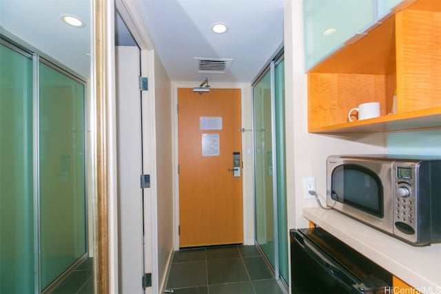 hall featuring dark tile patterned floors