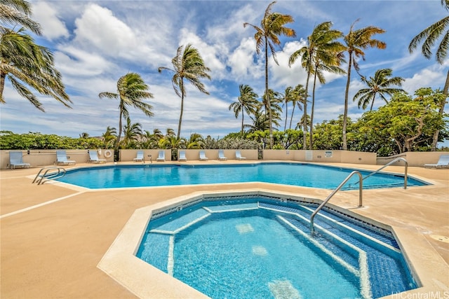 view of pool with a patio and a hot tub