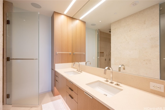 bathroom featuring vanity, an enclosed shower, and tile patterned floors