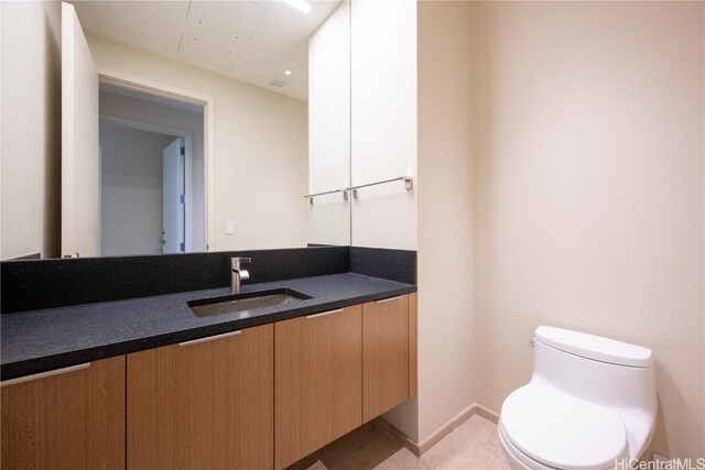 bathroom featuring vanity, toilet, and tile patterned flooring