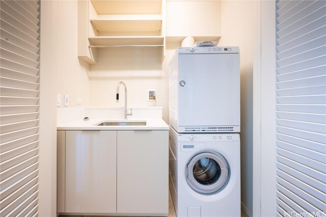 clothes washing area with sink and stacked washing maching and dryer