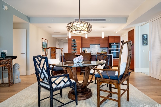 dining space with light hardwood / wood-style floors