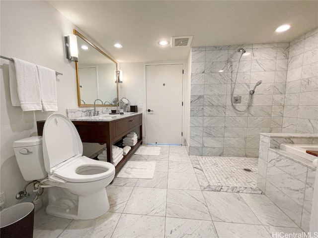 bathroom featuring vanity, tiled shower, and toilet