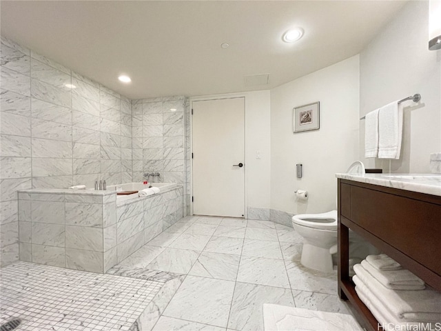 bathroom with toilet, a relaxing tiled tub, and vanity