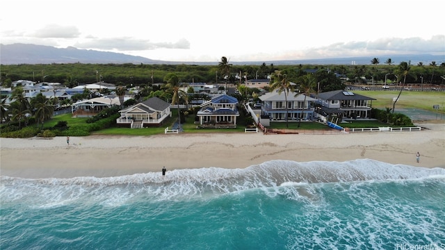 drone / aerial view featuring a water view and a beach view