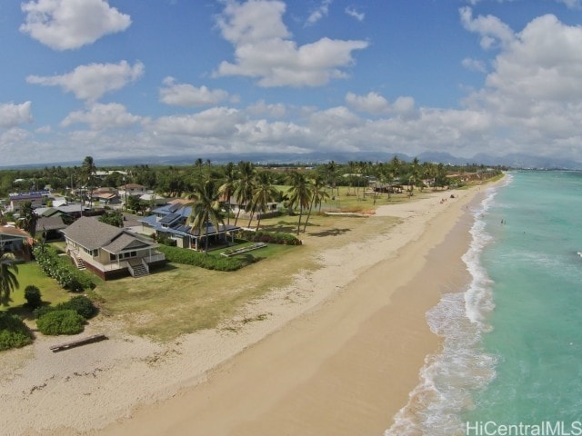 drone / aerial view with a water view and a view of the beach