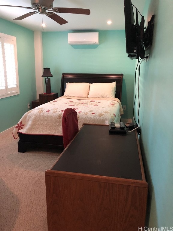 carpeted bedroom with an AC wall unit and ceiling fan