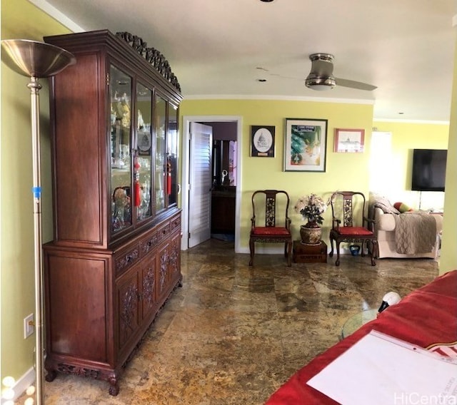 living room featuring ornamental molding and ceiling fan