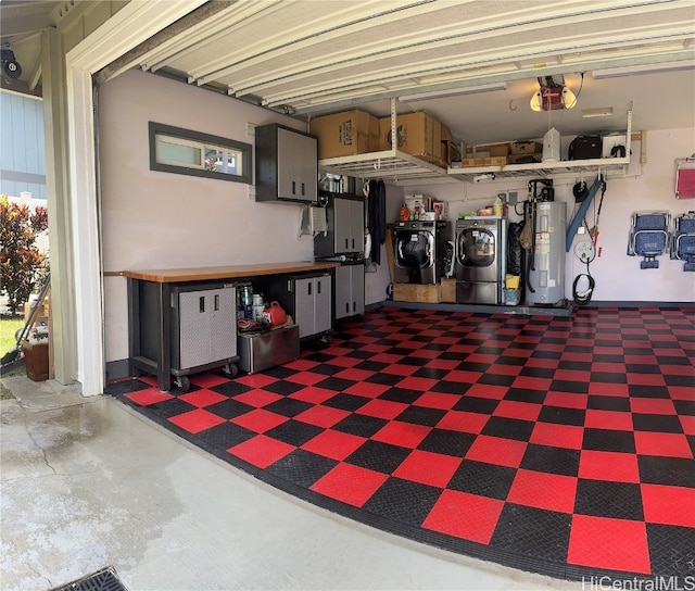 garage featuring a garage door opener, electric water heater, and washer and clothes dryer