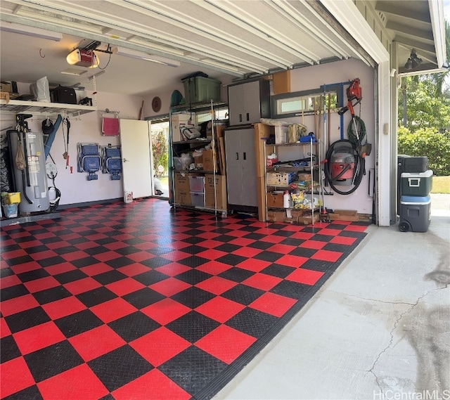 garage featuring water heater and a garage door opener