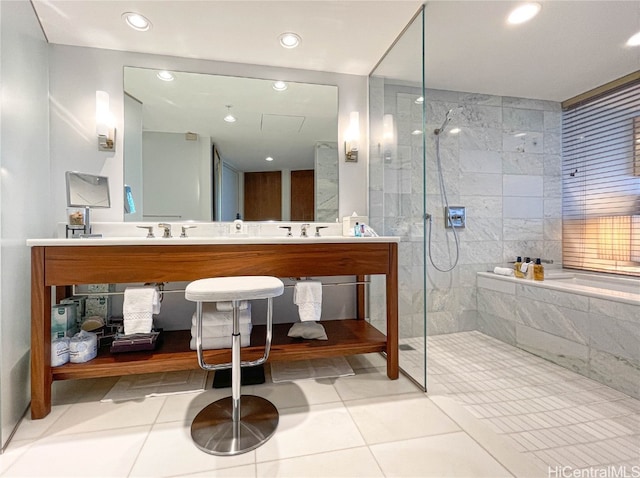 bathroom featuring vanity, a tile shower, and tile patterned floors