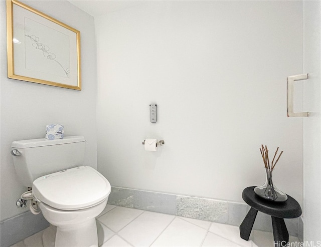 bathroom with toilet and tile patterned flooring