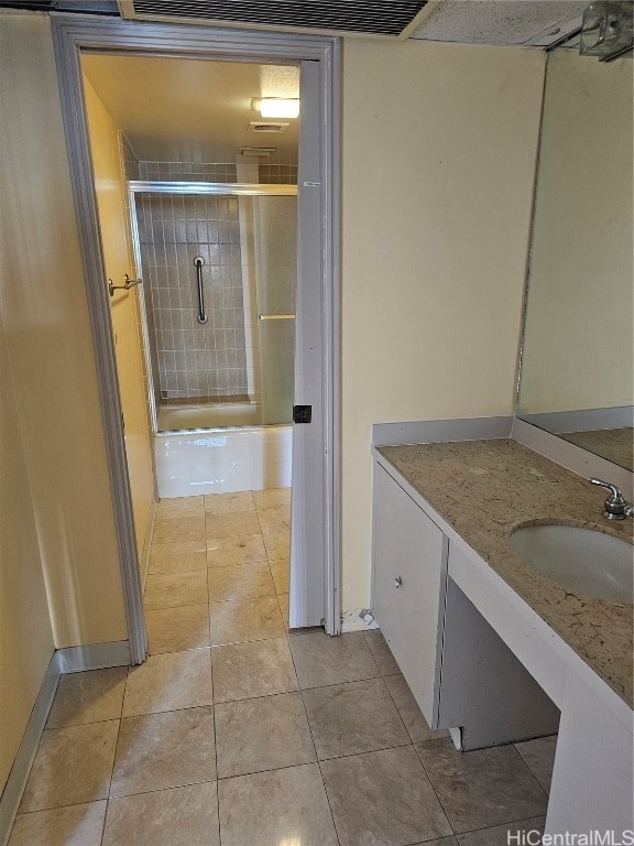 bathroom with vanity, shower / bath combination with glass door, and tile patterned flooring