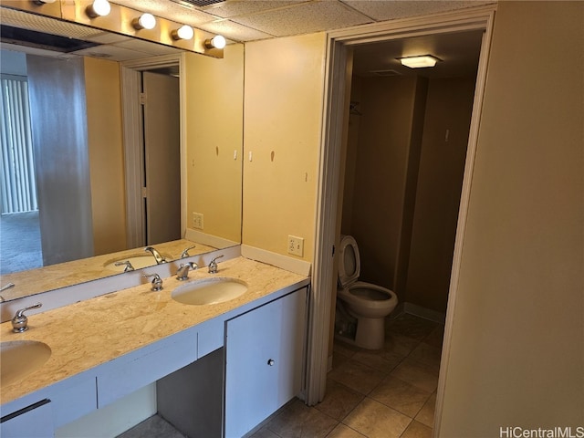 bathroom featuring vanity, toilet, and tile patterned flooring