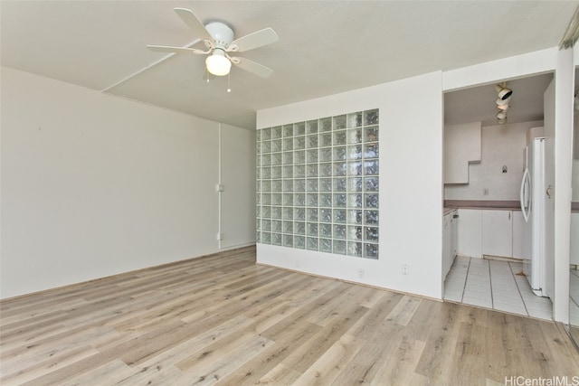 spare room featuring light hardwood / wood-style floors and ceiling fan