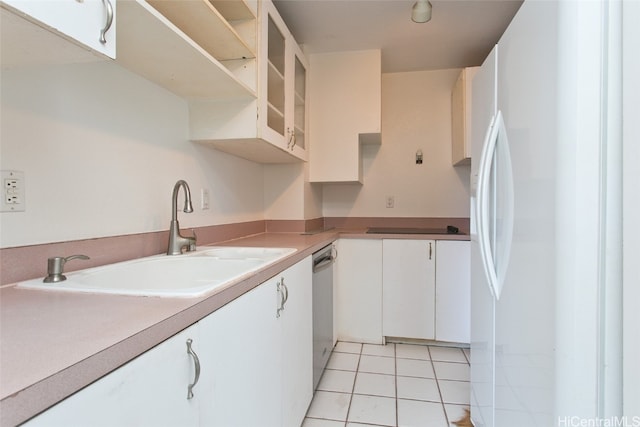 kitchen featuring dishwasher, light tile patterned floors, sink, white refrigerator, and white cabinets