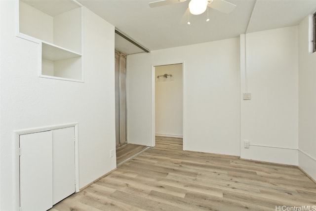 empty room featuring ceiling fan and light hardwood / wood-style flooring