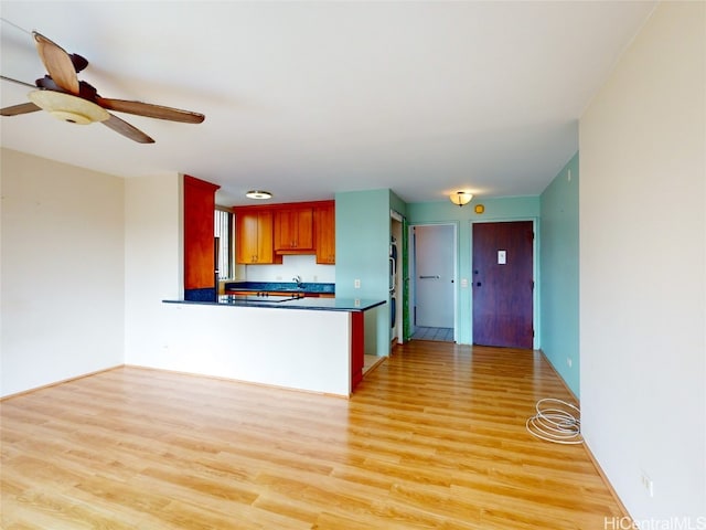 kitchen featuring ceiling fan, light hardwood / wood-style flooring, and kitchen peninsula