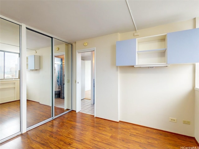 unfurnished bedroom with wood finished floors