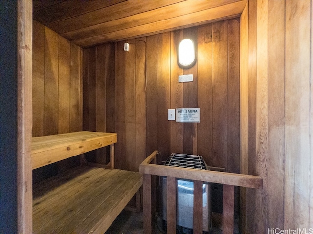 view of sauna / steam room featuring wood ceiling and wood walls