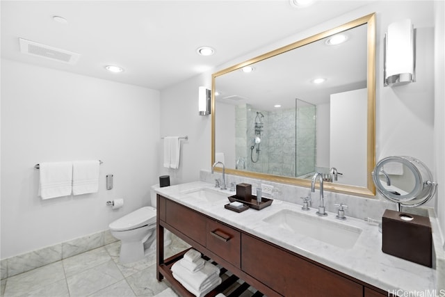 bathroom with vanity, a shower with shower door, and toilet