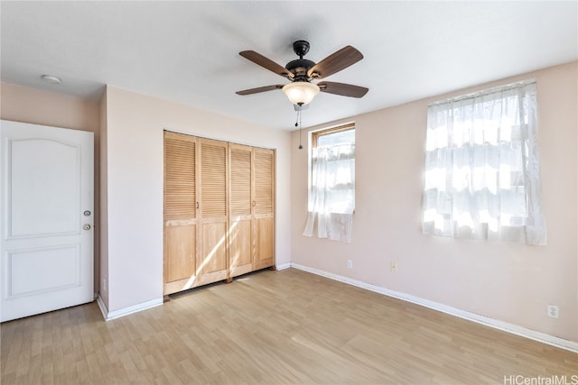 unfurnished bedroom with ceiling fan, light hardwood / wood-style floors, and a closet