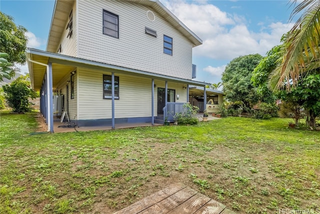 back of house featuring a yard and a patio area