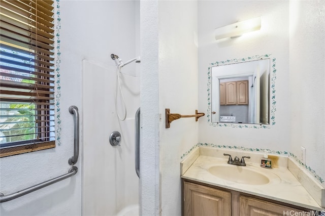 bathroom featuring vanity and walk in shower