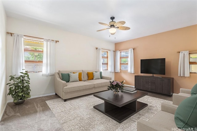 living room with light carpet, ceiling fan, and a healthy amount of sunlight