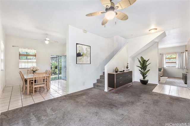 interior space with ceiling fan