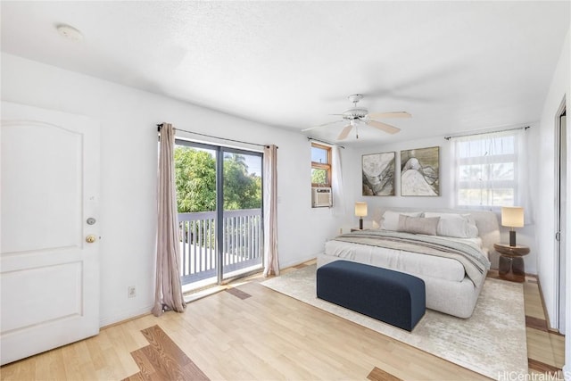 bedroom featuring access to exterior, ceiling fan, light hardwood / wood-style flooring, and cooling unit