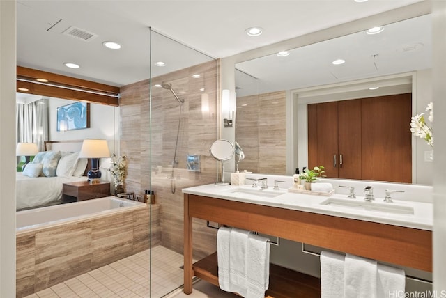 bathroom featuring vanity, shower with separate bathtub, and tile patterned floors