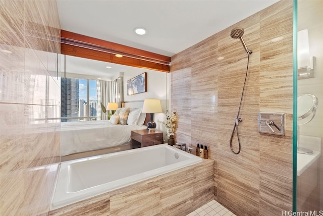 bathroom with plus walk in shower, tile walls, and tile patterned flooring