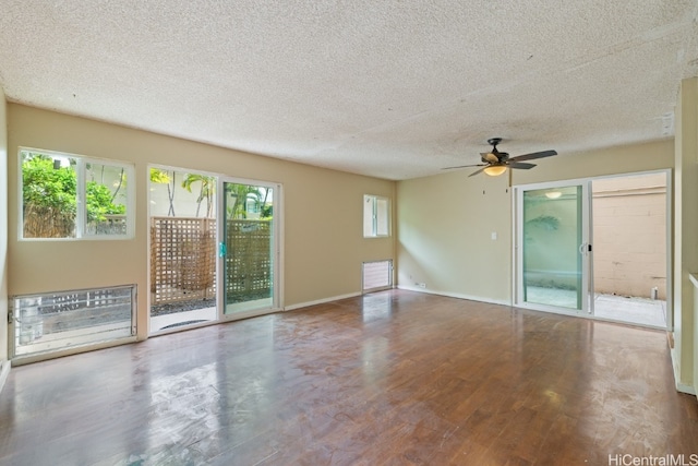 spare room with a textured ceiling, hardwood / wood-style flooring, and ceiling fan