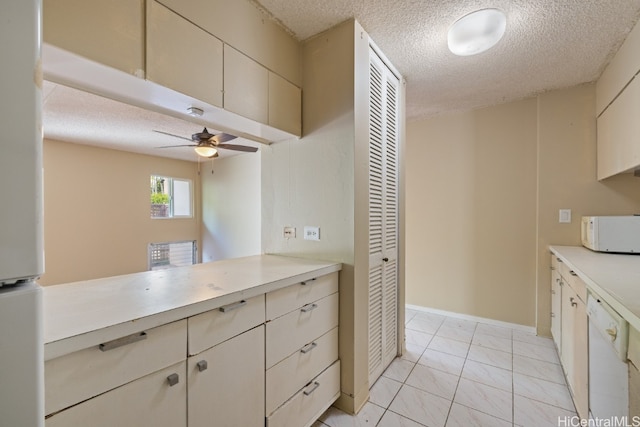 kitchen with white appliances, light tile patterned flooring, a textured ceiling, kitchen peninsula, and ceiling fan