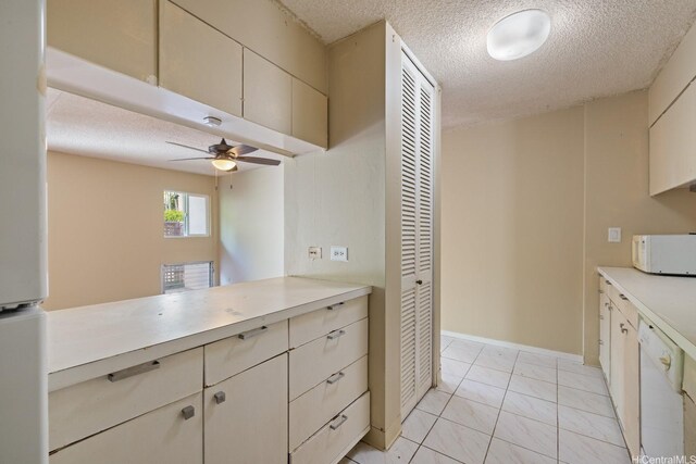 555 University Ave Unit 100, Honolulu, HI 96826 - kitchen with white appliances, a textured ceiling, light countertops, a ceiling fan, and light tile patterned floors