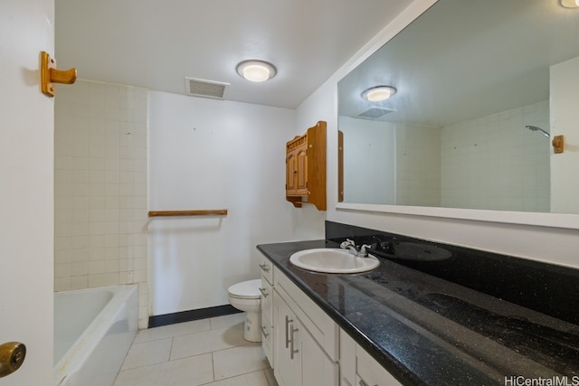 full bathroom with tiled shower / bath, vanity, toilet, and tile patterned floors