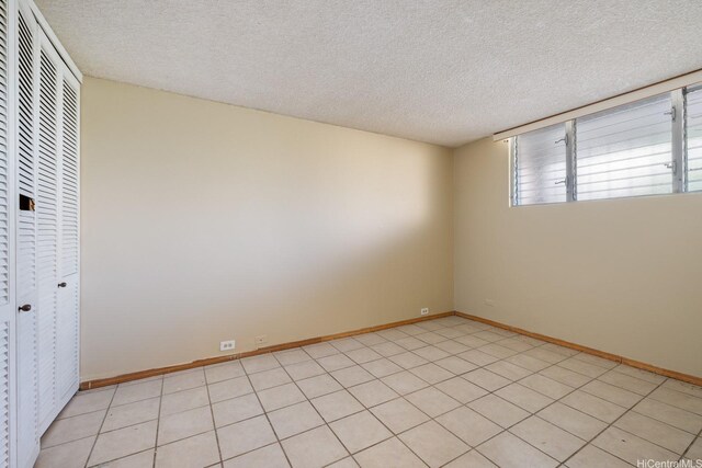 555 University Ave Unit 100, Honolulu, HI 96826 - unfurnished room featuring a textured ceiling and baseboards
