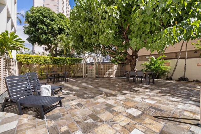 555 University Ave Unit 100, Honolulu, HI 96826 - view of patio / terrace featuring outdoor dining space and fence